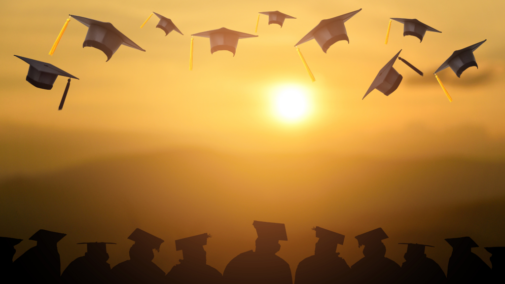 graduation caps on yellow background